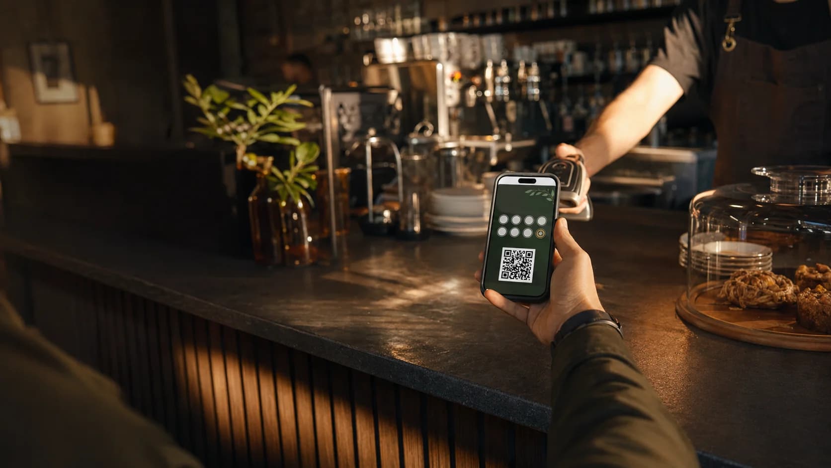 A member presenting a phone wallet loyalty pass at a venue counter
